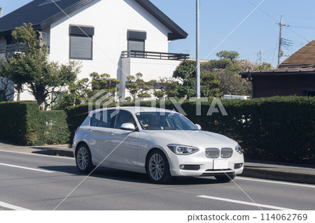 Compact car driving on road Compact car driving on road 114062769
