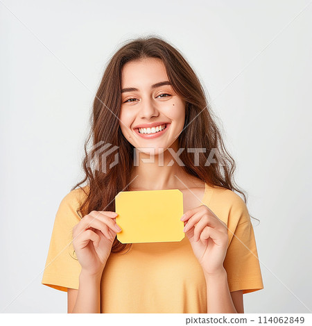 smiling woman holding a sign, a piece of paper in her hands 114062849