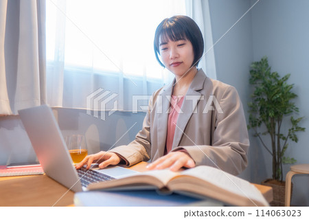 A woman studying at home/working remotely A woman studying at home/working remotely 114063023