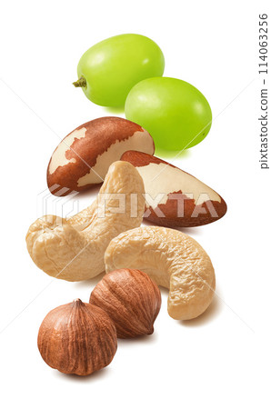 Cashew, hazelnut, brazil nuts and green grapes isolated on white background. Vertical layout Cashew, hazelnut, brazil nuts and green grapes isolated on white background. Vertical layout 114063256