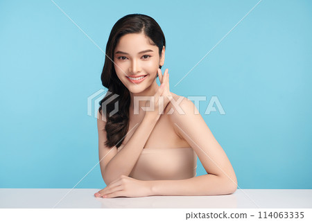Beautiful Young transgender woman with clean fresh skin on blue background, Face care, Facial treatment, Cosmetology, beauty and spa, transgender women portrait. 114063335