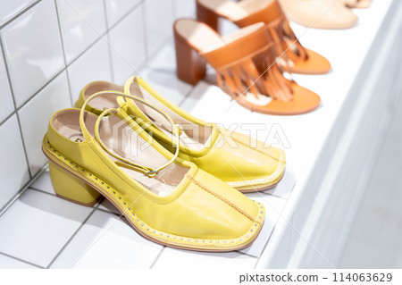 Shoes lined up in a store 114063629
