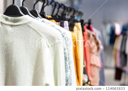 Clothes lined up in a store 114063833