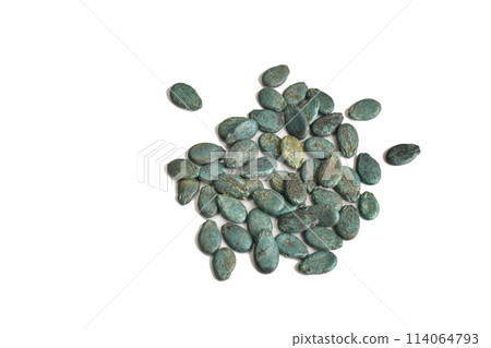 Dry watermelon seeds in a protective shell on a white background. 114064793