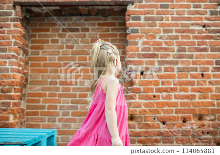 Child girl walks and have fun outdoor with cochlear implant on the head. Hearing aid and treatment concept. Inclusion and disability. Child girl walks and have fun outdoor with cochlear implant on the head. Hearing aid and treatment concept. Inclusion and disability. 114065881