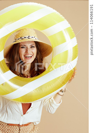 smiling stylish woman in blouse and shorts isolated on beige 114066191