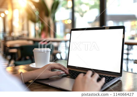 Woman using laptop in office sitting at cafe. Empty blank white screen mockup. Copy space area for text, logo, app. Person working, female hands typing. Mock up display PC. Business websites, service 114066427