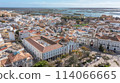 Traditional Portuguese town of Faro on oceanfront with old architecture, filmed by drone. Ria formosa in background. 114066665