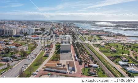 The Portuguese oceanfront city of Faro overlooking a theater, filmed with a drone. Ria Formosa in background. Algarve. The Portuguese oceanfront city of Faro overlooking a theater, filmed with a drone. Ria Formosa in background. Algarve. 114066670