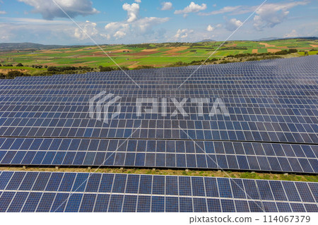 Rows of solar panels on the green meadow in Greece. Aerial view. Rows of solar panels on the green meadow in Greece. Aerial view. 114067379