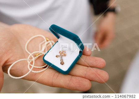 Gold baptismal cross in a box 114067982