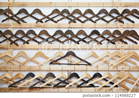 Empty wooden hangers 114068227
