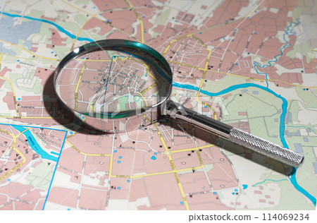 World map under magnifying glass, exploring new destinations. Travel and tourism planning, journey 114069234