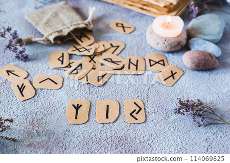 Prediction from three Scandinavian runes on a table in mystical decor 114069825