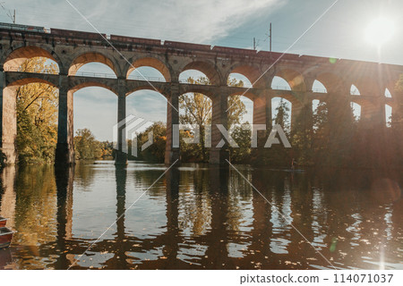 Railway Bridge with river in Bietigheim-Bissingen, Germany. Autumn. Railway viaduct over the Enz River, built in 1853 by Karl von Etzel on a sunny summer day. Bietigheim-Bissingen, Germany. Old 114071037