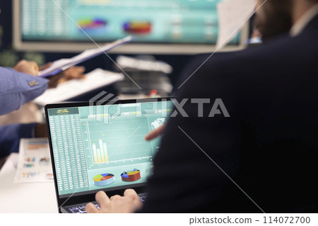 Team of affiliates working on resource allocation reports during a conference, making important budgeting decisions to corelate with company goals. Teammates review strategies. 114072700