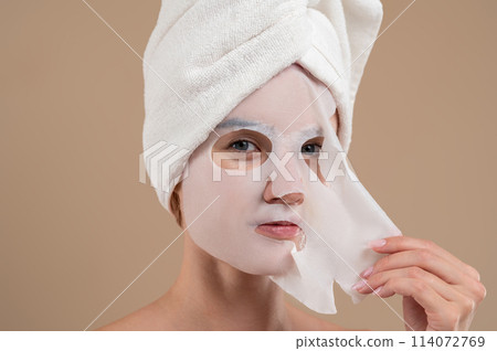 Young woman with rejuvenating mask on face Young woman with rejuvenating mask on face 114072769