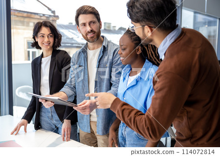 Employees engaged in teamwork talking about business concepts in coworking space 114072814