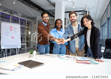 Happy diverse business people putting hands together 114072845
