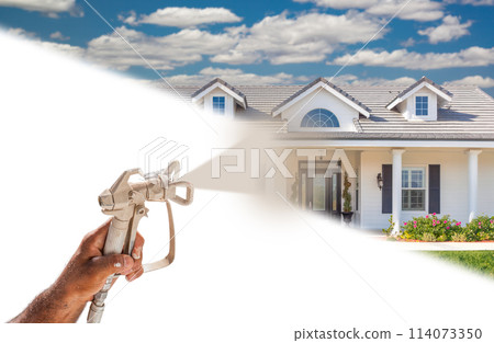 Professional Spray Painter Holding Spray Gun Spraying New House Over White Surface. Professional Spray Painter Holding Spray Gun Spraying New House Over White Surface. 114073350