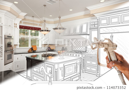 Professional Spray Painter Holding Spray Gun Spraying Renovated Kitchen Over Design Drawing. Professional Spray Painter Holding Spray Gun Spraying Renovated Kitchen Over Design Drawing. 114073352