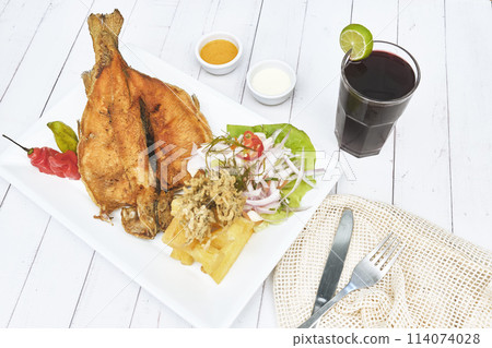 PERUVIAN FOOD, typical dish Fried trout, with rice, yucca and salad, Sective Focus PERUVIAN FOOD, typical dish Fried trout, with rice, yucca and salad, Sective Focus 114074028