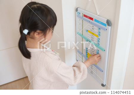 Child using a preparation board 114074451