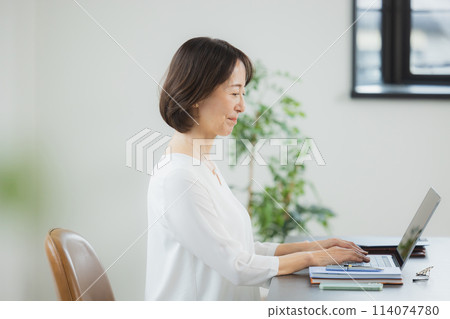 操作計算機的一位資深婦女 114074780