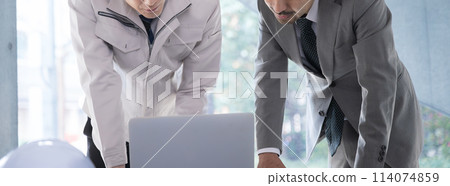 Site supervisor and construction management engineer checking construction drawings. Horizontal image of real estate, building design and construction management. No face. Mouth. Site supervisor and construction management engineer checking construction drawings. Horizontal image of real estate, building design and construction management. No face. Mouth. 114074859