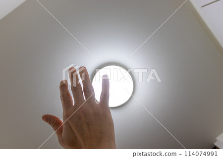 Block the light from the ceiling light with your hand Block the light from the ceiling light with your hand 114074991