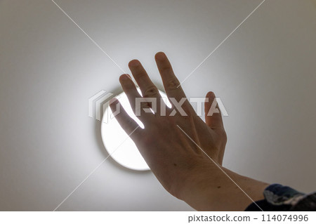 Block the light from the ceiling light with your hand Block the light from the ceiling light with your hand 114074996