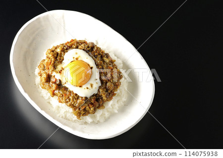 黑色背景下,頭頂上放著蛋黃和燒焦起司的基瑪咖哩的照片 黑色背景下,頭頂上放著蛋黃和燒焦起司的基瑪咖哩的照片 114075938