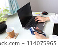Woman's hands typing on a computer at home 114075965