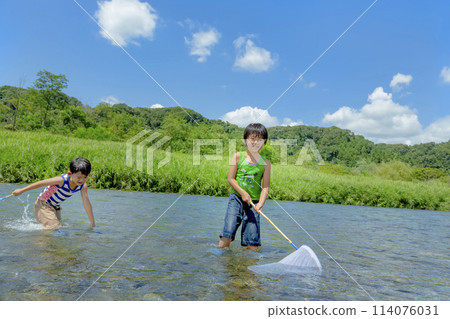 Boys playing on the riverbank in summer Boys playing on the riverbank in summer 114076031
