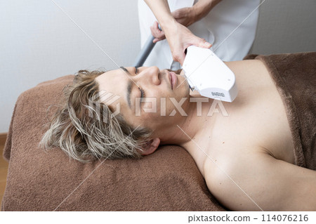 A man receiving beard hair removal treatment A man receiving beard hair removal treatment 114076216