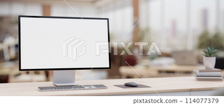 A white-screen PC computer on a minimalist wood table in a contemporary office co-working space. 114077379