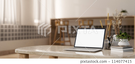 A laptop computer mockup and decor on a marble coffee table in a cozy minimalist living room. 114077415