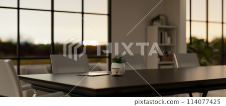 A black meeting table in a contemporary meeting room with amazing large windows. 114077425