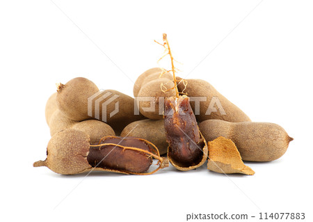 Tamarind whole and cracked open on white background 114077883