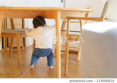 Baby hiding under the table Baby hiding under the table 114080610