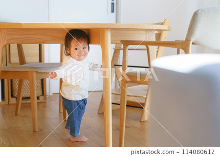 Baby hiding under the table Baby hiding under the table 114080612