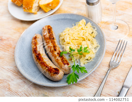 Fried sausages served with pickled cabbage Fried sausages served with pickled cabbage 114082751