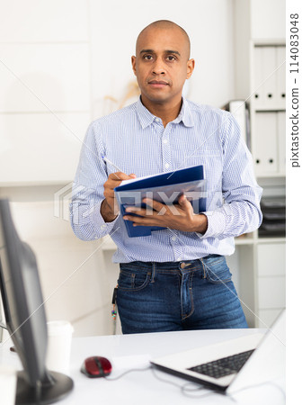 Businessman makes notes in the document at office Businessman makes notes in the document at office 114083048