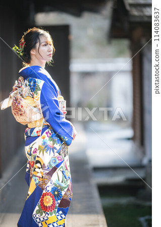 A beautiful young Japanese woman walking in a kimono A beautiful young Japanese woman walking in a kimono 114083637