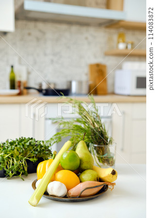 Fresh vegetables and fruits on a kitchen table 114083872