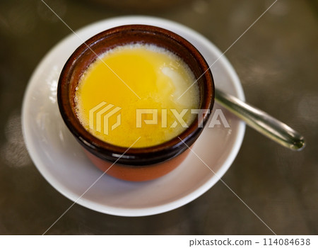Clay pot contains fermented milk curd with honey 114084638