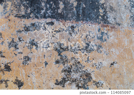 Black and brown surface of a fuzzy wall with cracks 114085097