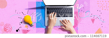 Person using a laptop computer and a light bulb Person using a laptop computer and a light bulb 114087119