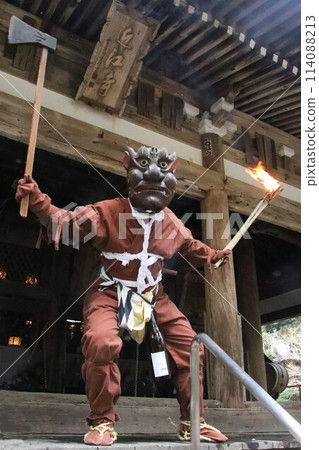 Old woman demon holding up a torch and an axe 114088213