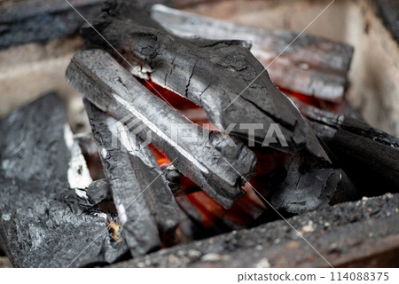 Burning charcoal Burning charcoal 114088375